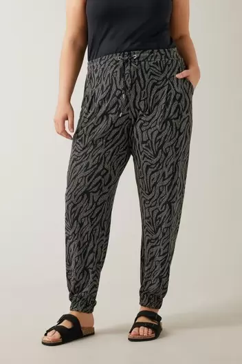 EVANS Curve Black Animal Markings Jersey Tapered Trousers offers at £15 in Evans