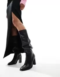 London Rebel Maggie wide fit slouchy block heel boots in black offers at £42 in ASOS