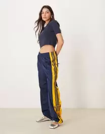 Adidas Originals Adibreak track pants in navy and yellow offers at £65 in ASOS